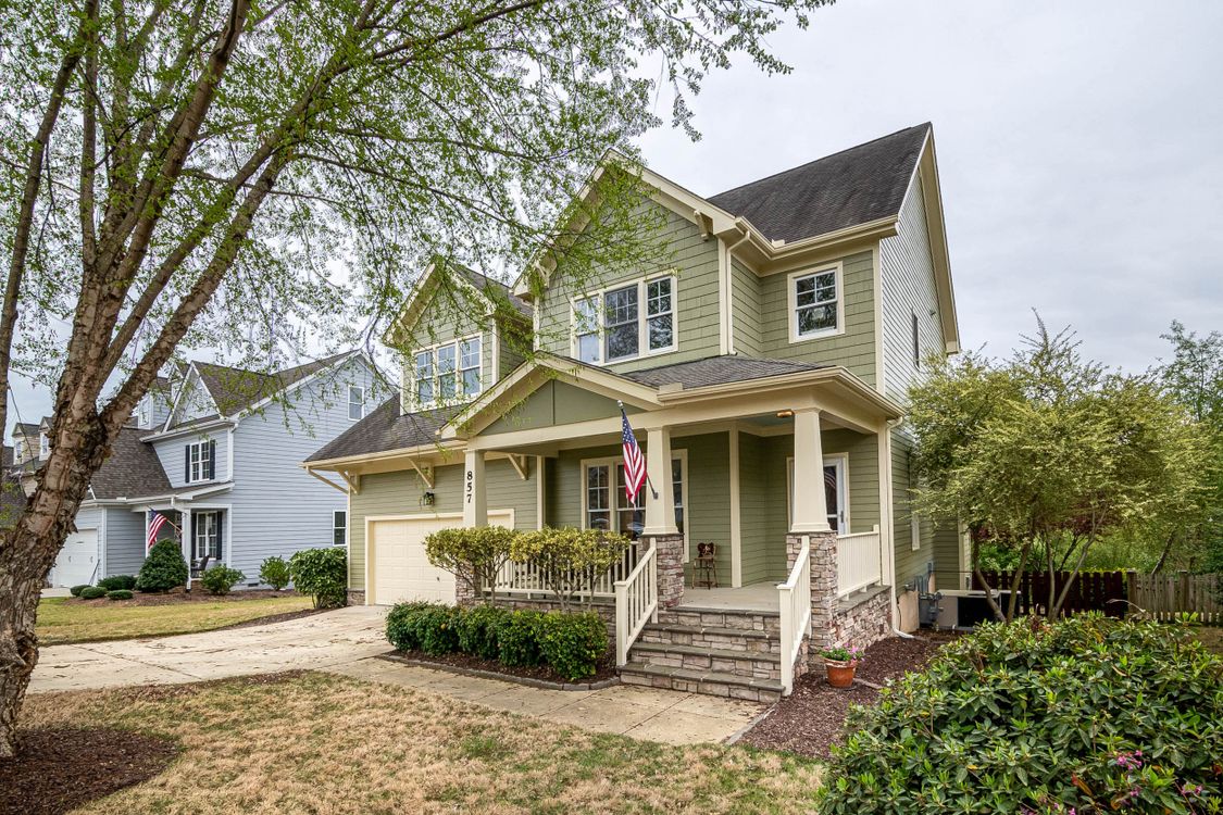 An American flag displayed on a welcoming suburban front porch